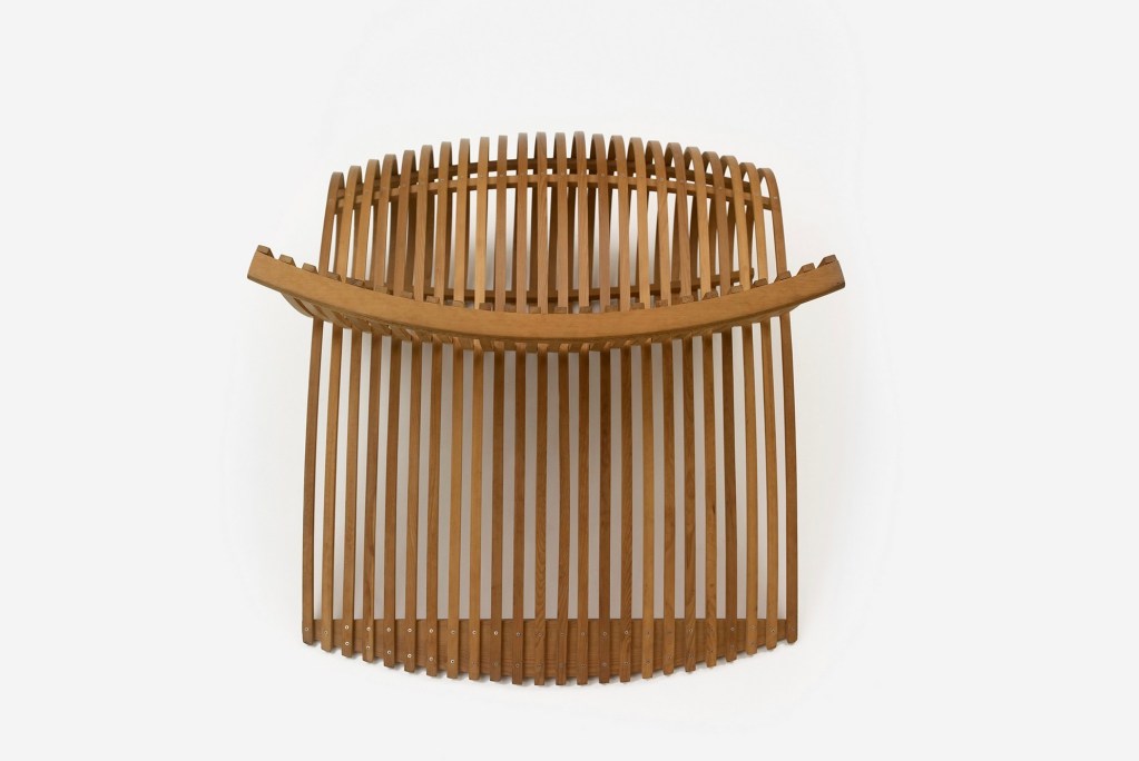 Overhead view of Marc Newson’s Wood Chair, showing its symmetrical slatted structure and curved seat formation.